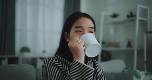 Young Woman Drinking Coffee at Home