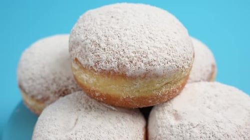 Donuts Covered in Powdered Sugar on Blue