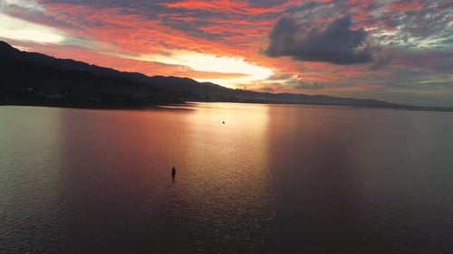 Aerial view of a boat on the lake at sunset with beautiful sky