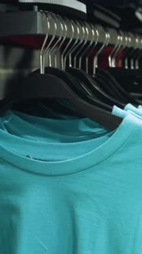 FirstPerson View of Clothing Store with Blue and White Clothes on Hangers