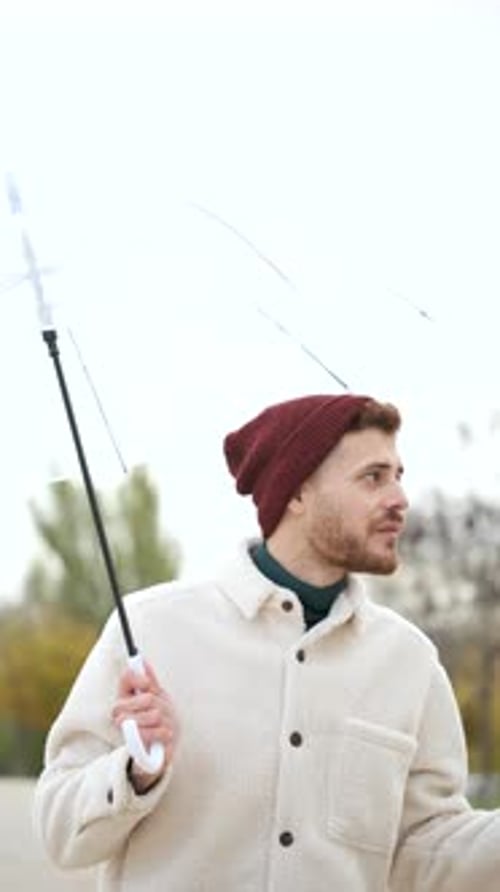 Man Under Umbrella In Urban Environment