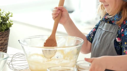 Little Girl Baker Puts the Ingredients for Kneading the Dough