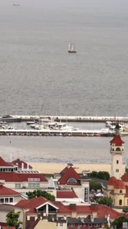 Vertical drone shot around boats at the Sopot Marina, summer day in Poland