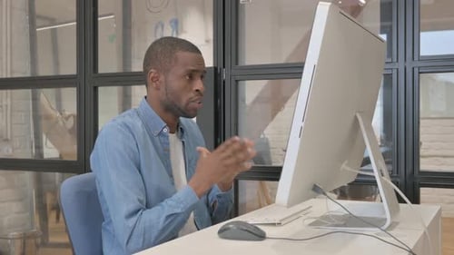Adult Attends Video Conference at Desk