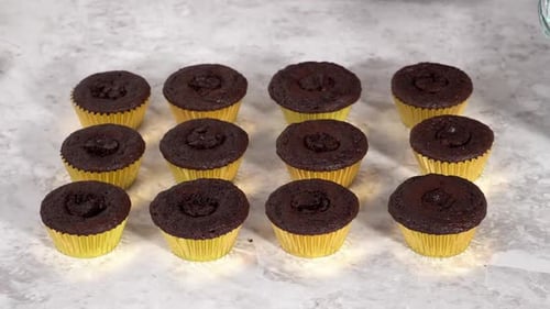 Decorating Chocolate Cupcakes with Buttercream Frosting and Rainbow Candy