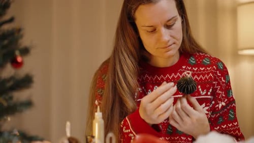 Woman Making Christmas Ornament at Table