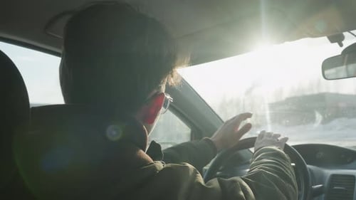 Young Adult Driving Car on a Sunny Day