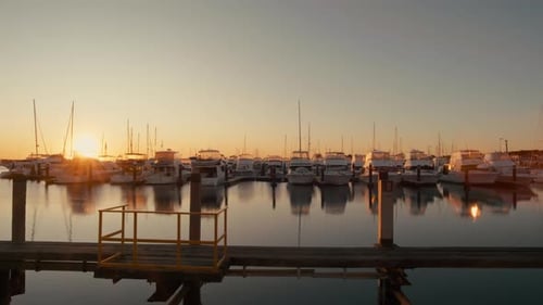 Harbor and marina with moored yachts at sunset
