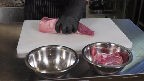 Chef Cuts Pork Loin into Slices for Cooking