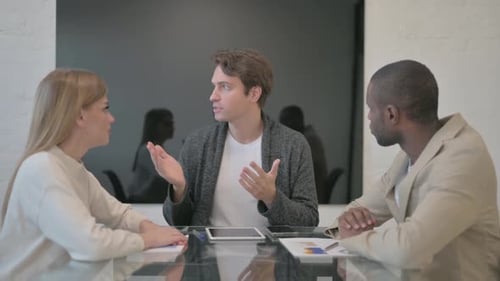 Team Meeting at Conference Table in Modern Office