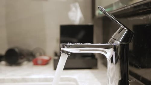 turn on running water flows from the tap to the white sink and turn off