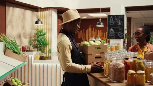 Grocer Stacks Produce at Bright Organic Market