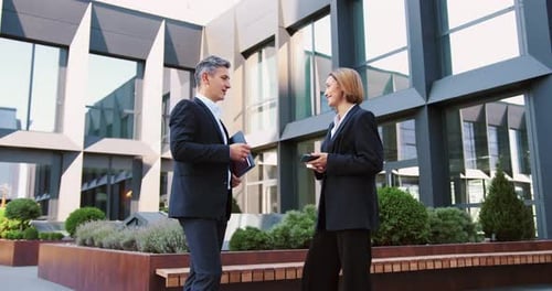 Smiling Mature Male and Female Colleagues Discuss Work Over Business Lunch and Shaking Hands Man