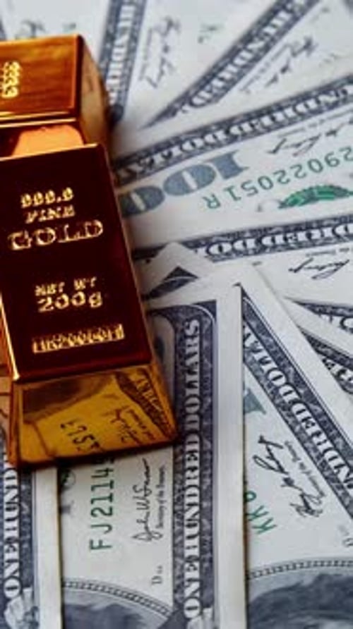 Shiny Gold Bars Slowly Spin Hundred Dollar Bills Showing Wealth Investment Power