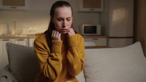 Woman Coughing and Clutching Throat in Home Setting