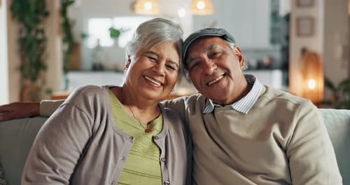 Old couple, face and hug in home for support, commitment and love for comfort in lounge