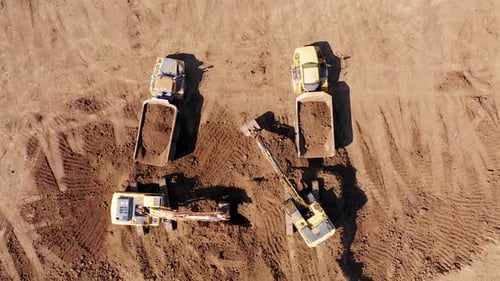 Excavators Fill Trucks with Soil Aerial View