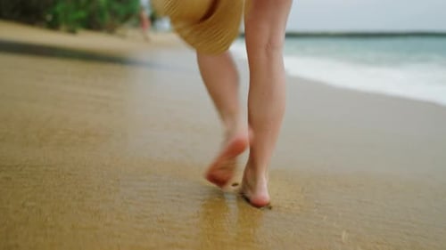 Slim Female Legs and Feet Walking Along Sea Water Waves on Sandy Beach Pretty Woman Walks at Seaside