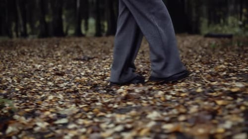 Closeup of Woman Walking Nervously Through Dark Autumn Forest