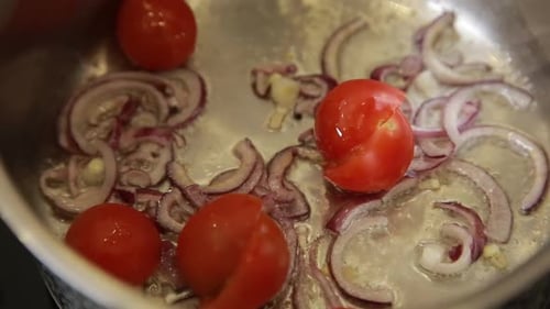 Red Onions and Tomatoes Sautéing in a Pan
