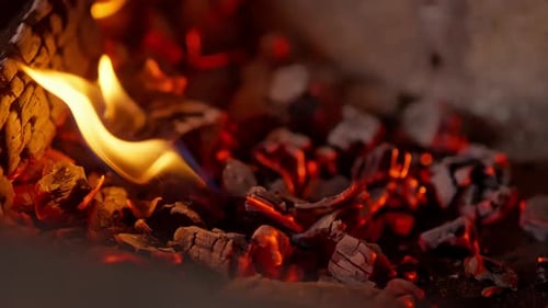 Embers and Flames: Glowing Charcoal Fire Close-up