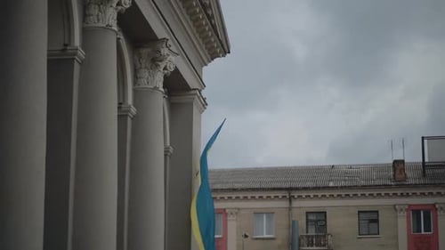 Flag blowing in wind near building in urban area