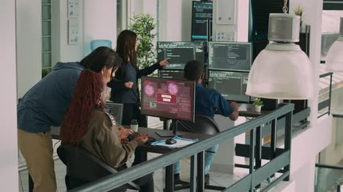 Diverse Team Collaborating on Code in Modern Office