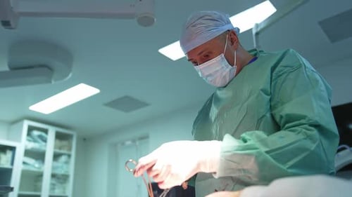 Liposuction procedure to a patient with surgical tools.