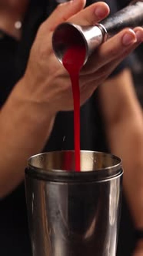 A bartender prepares an alcoholic cocktail at the bar. Close up