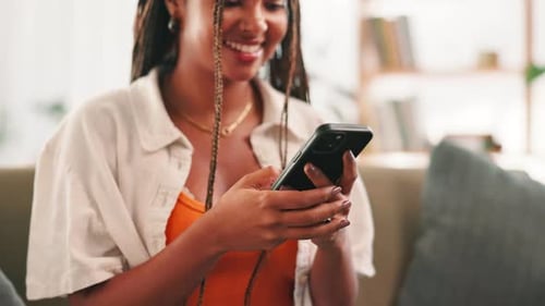 Smiling Woman Using Smartphone Device at Home