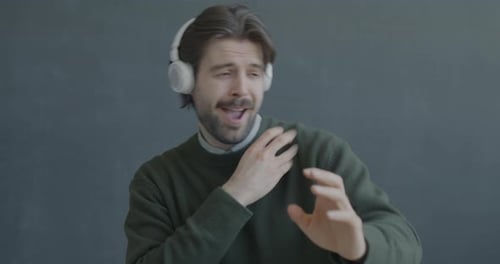 Man with Headphones Dancing and Listening to Music