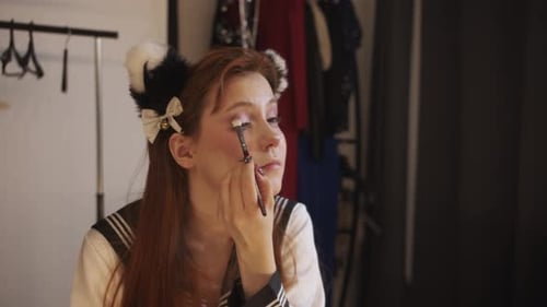 Woman Applies Makeup Wearing Animal Ears