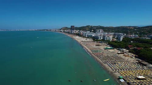 Beach on the Adriatic Sea with sand and pines, hotels, and resorts to book for summer vacations in M