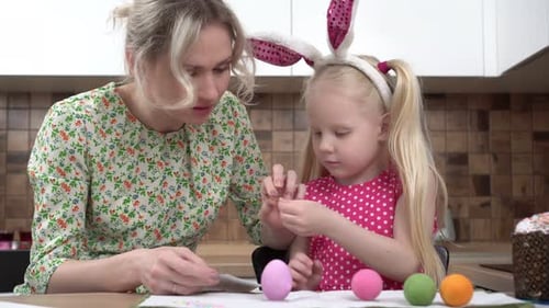 Mother and Child Paint Eggs for the Easter Holiday
