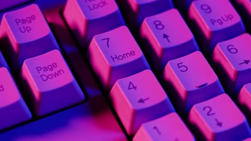 Close Up of Keyboard in Pink and Blue Lighting