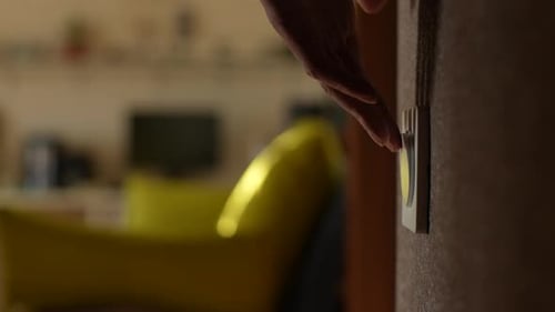 Close Up Side Cropped Shot of Unrecognizable Male Turning Light on and Off By Pushing Household