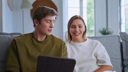 Couple Relaxing at Home with Tablet Device