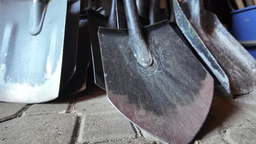 A close-up video of several shovels arranged in an overlapping manner.