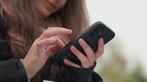 Girl Using Mobile Phone Technology in an Urban Setting