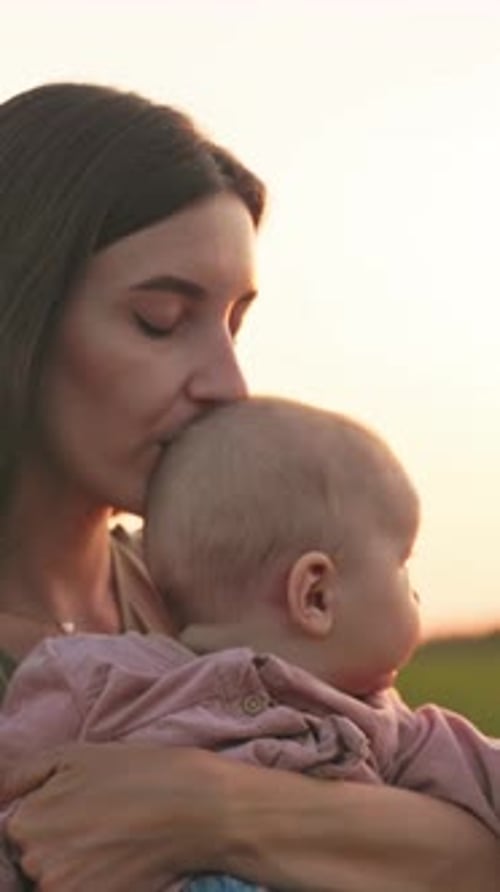 Affectionate Mother with Baby at Sunset