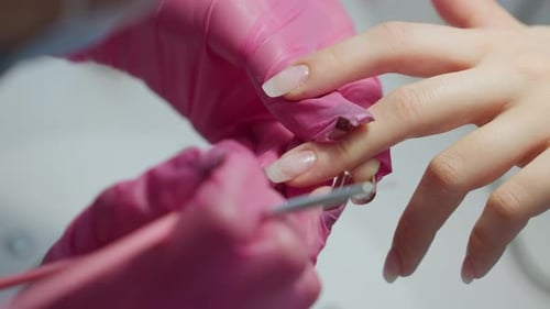 Manicurist Applying Nail Polish in Salon