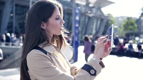 Woman Using Tablet in Sunny Urban Environment