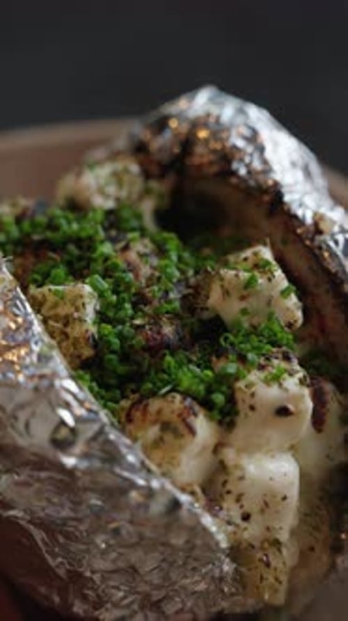 Baked Potato in Foil with Herbs Close Up
