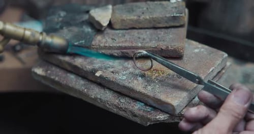 Jeweler Solders a Silver Blank with a Gas Burner in the Process of Creating a Jewelry Ring