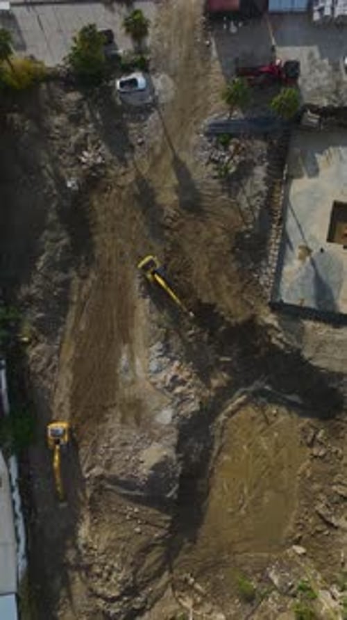 Vertical Video Scenic View of a Building Under Construction With Cranes and Workers Captured