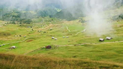 Green Valley with Paths and Houses Near Seceda Mountain