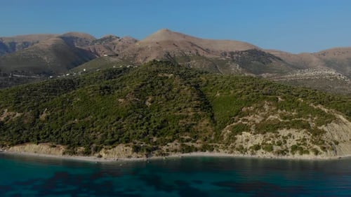 Mediterranean coastline with hills and mountains surrounded by turquoise sea on summer