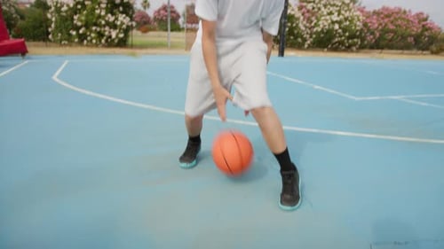 Blond Athlete Dribbles In Outdoor Basketball Court