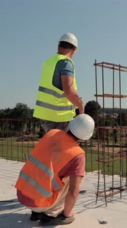 Engineers Inspecting Steel Reinforcement at Construction Site Two Construction Engineers in Safety