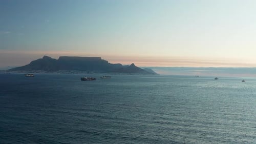 Cargo Vessels Sailing On The Coast Of South Africa With Cape Town In The Distance. - aerial